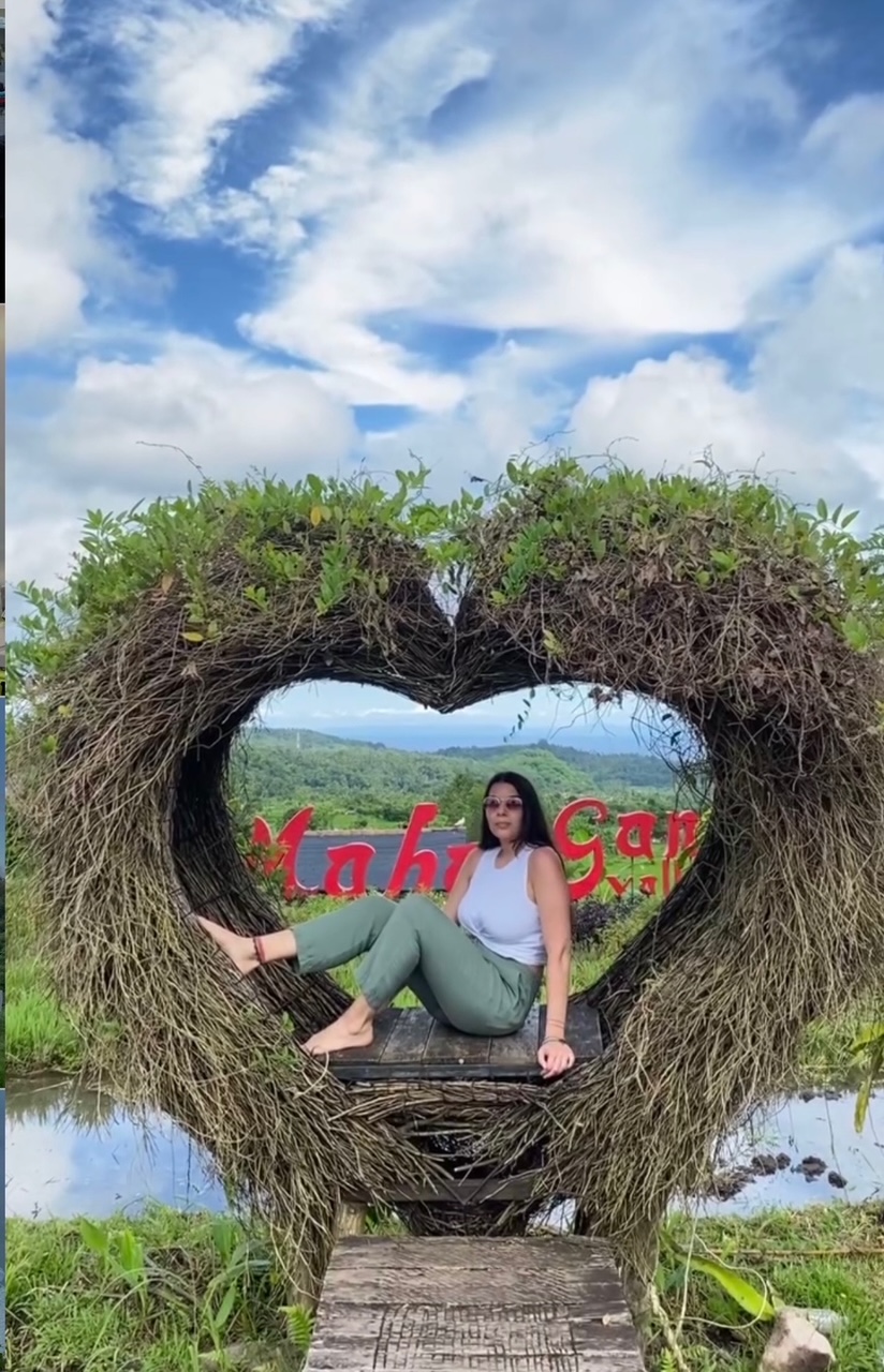 Customers posing in a heart-shaped Bali photo spot