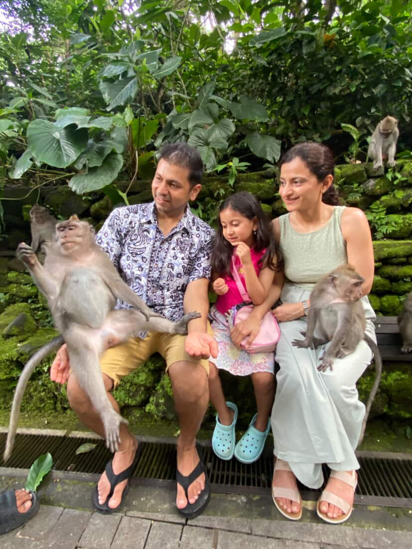 Family sitting with monkeys during an Ubud tour