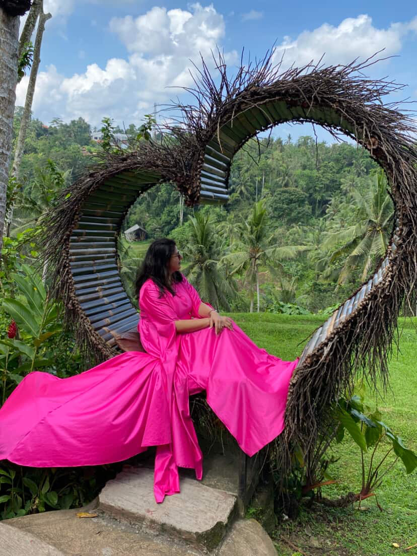 Customer posing in a heart-shaped nest in Bali